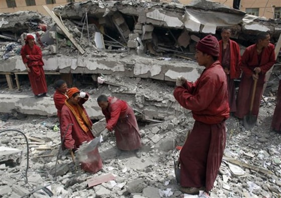 Rescuers, including Tibetan monks, probed the rubble for sounds or movement Friday in a rush to find anyone buried alive in western China.